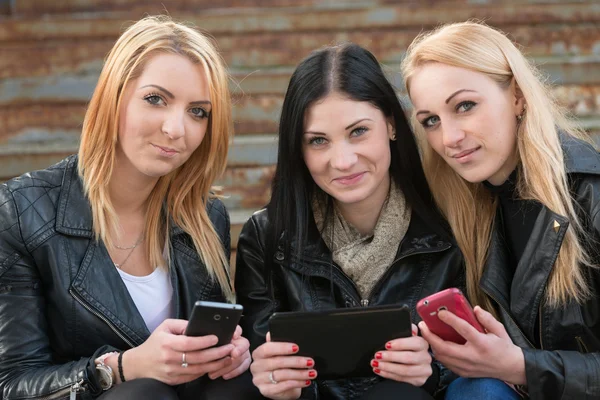 Девушки, использующие цифровые планшеты и мобильные телефоны — стоковое фото