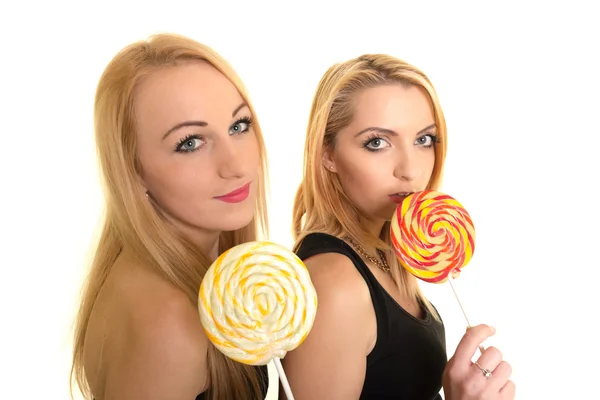 Two girls with candies — Stock Photo, Image