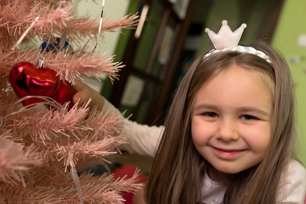 Klein meisje versieren kerstboom — Stockfoto