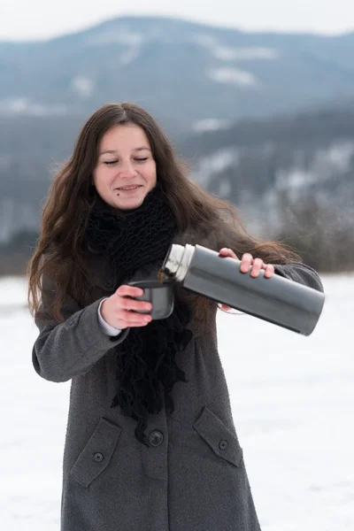 Girl drinking hot tea in the winter — Stock Photo, Image