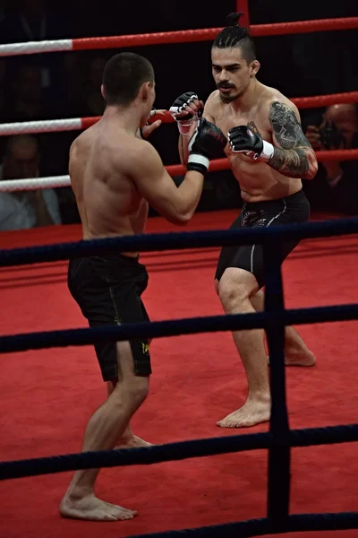 Forte combattente e il suo avversario durante un combattimento in un ring Combat Fight Night — Foto Stock