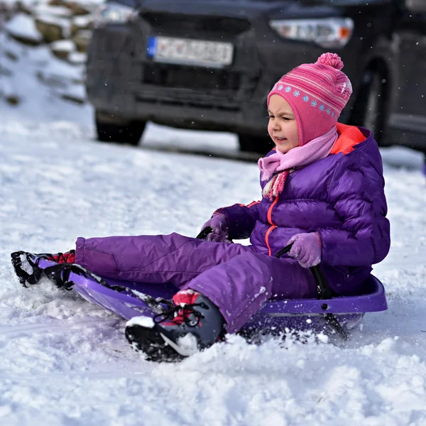 Girl sledding in winter — Stock Photo, Image