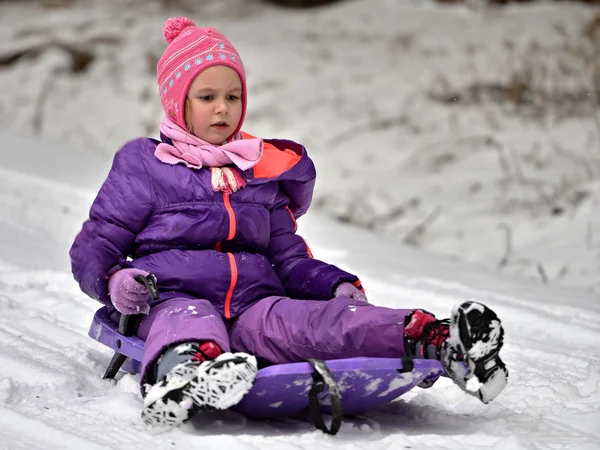 Girl sledding in winter — Stock Photo, Image