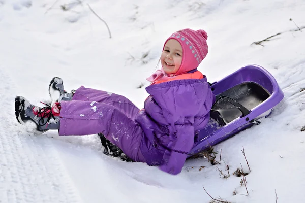 Girl sledding in winter Royalty Free Stock Images