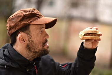 Man eating a hamburger clipart