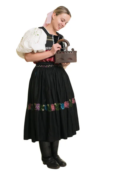 Woman in slovakian folk costume with old iron — Stock Photo, Image