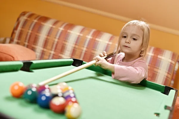 Cute little girl playing pool — Stock Photo, Image