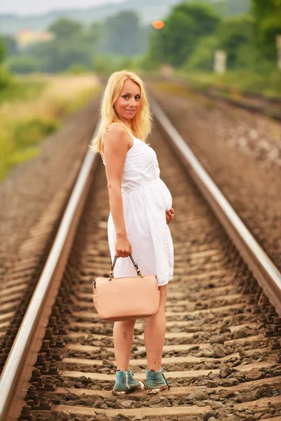 Pregnant woman on rails — Stock Photo, Image