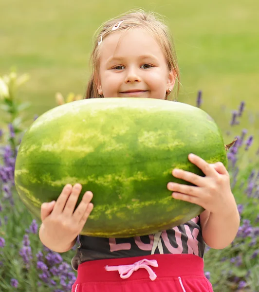 Cute little girl holding watermelon — Stock Photo, Image