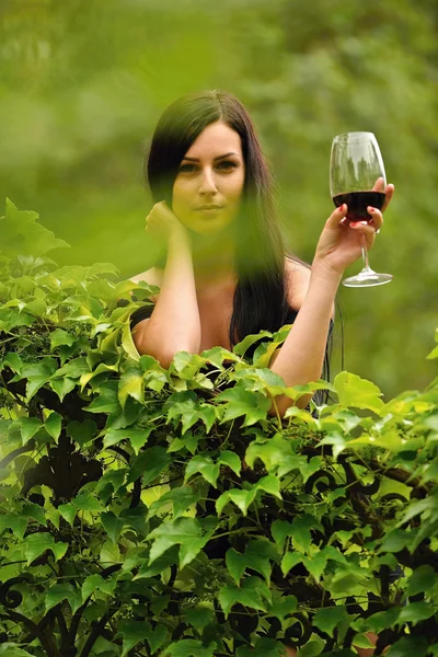 Ragazza in giardino con vino — Foto Stock