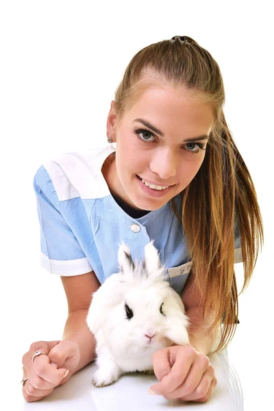 Smiling vet holding up and examining cute white rabbit — Stock Photo, Image