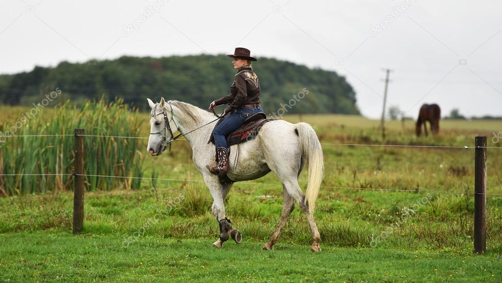 cowgirl  in a barrel race at a rodeo.