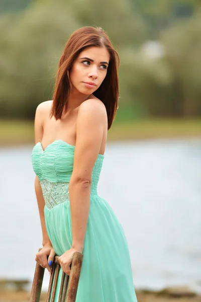 Young girl posing with chair — Stock Photo, Image