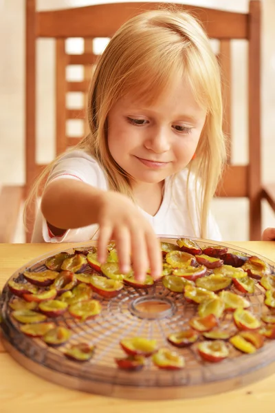 Girl with dried plums — Stock Photo, Image