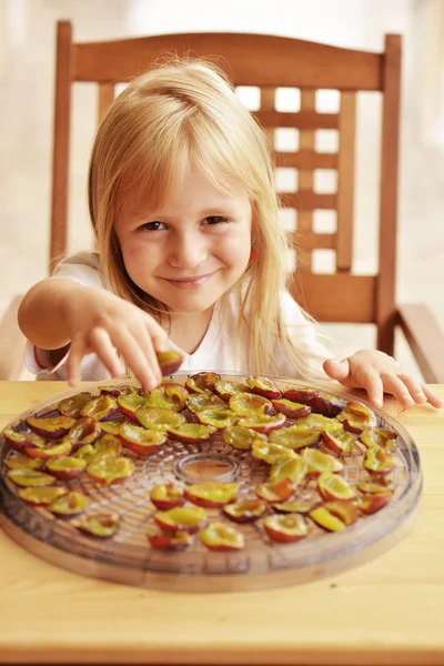 Girl with dried plums — Stock Photo, Image