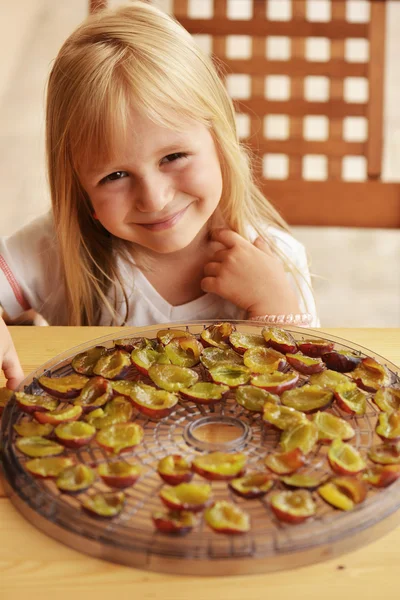 Girl with dried plums — Stock Photo, Image