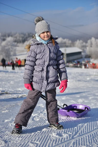 Little girl with sleigh — Stock Photo, Image