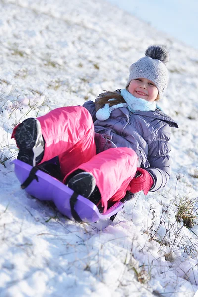 Little girl on sleigh — Stock Photo, Image