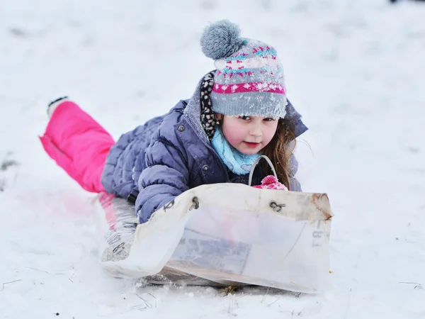 Little girl enjoying a sleigh ride — Stock Photo, Image