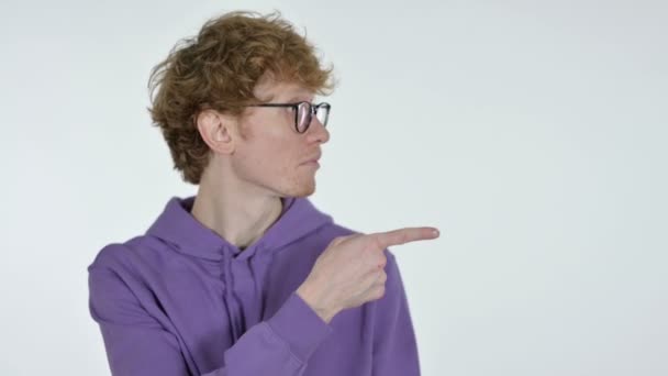 Copy space, Redhead Young Man Pointing with Finger, White Background — Stok Video