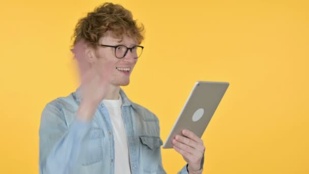 Video Call on Tablet by Redhead Young Man, Yellow Background — Stock Video