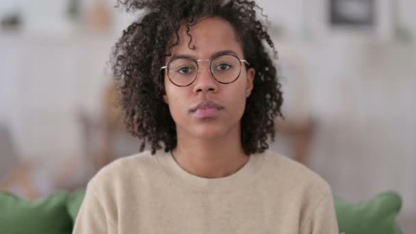 Retrato de una joven africana mirando a la cámara en casa — Vídeos de Stock
