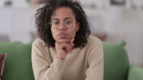 Young African Woman Sitting and Thinking on Sofa — Stock Video