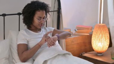 Yatakta Smartwatch kullanan Güzel Afrikalı Kadın 