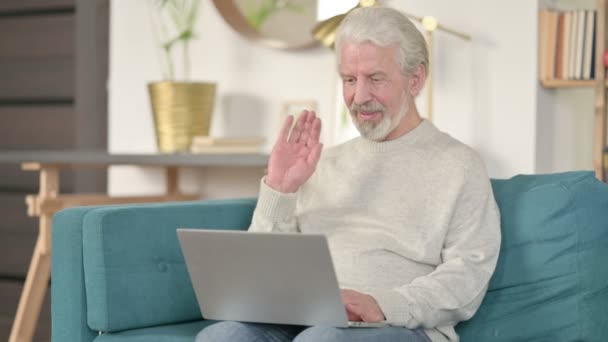 Online videogesprek op laptop door senior oude man op de bank — Stockvideo