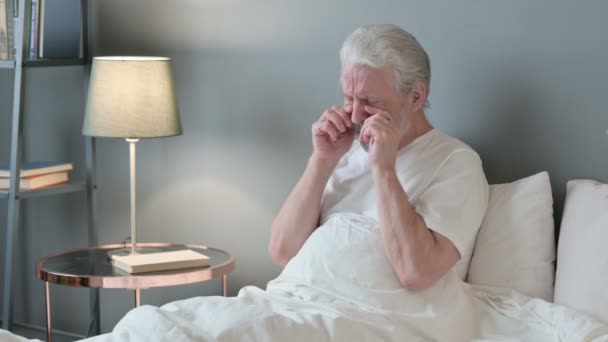 Üzgün yaşlı adam yatakta oturup ağlıyor. — Stok video