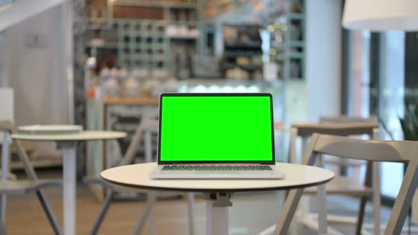 ซูมเข้าของแล็ปท็อปที่มีหน้าจอโครเมี่ยมสีเขียวในคาเฟ่ — วีดีโอสต็อก