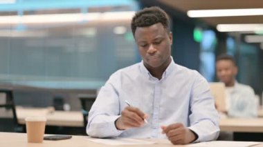 Afrikalı İşadamı Kağıt ve Başarısızlık Üzerine Yazmaya Çalışıyor 