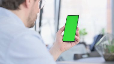 Gözlüklü Adam Yeşil Ekran ile Akıllı Telefon Kullanıyor 