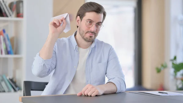 Hombre en gafas con avión de papel volador portátil — Foto de Stock