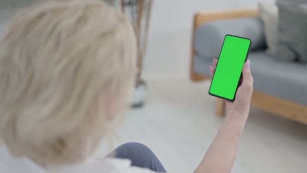 Vue arrière de la vieille femme âgée regardant Smartphone avec écran Chroma Key sur tapis de yoga — Video