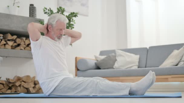 Vieil homme âgé faisant des étirements sur tapis de yoga à la maison — Video