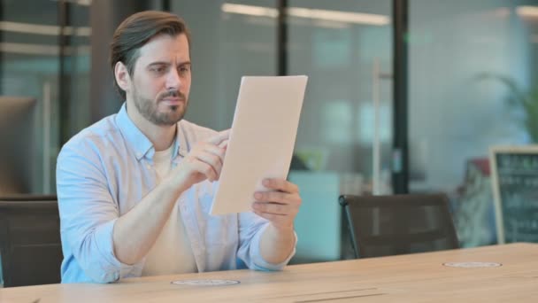 Reifer erwachsener Mann feiert Erfolg beim Lesen von Dokumenten — Stockvideo
