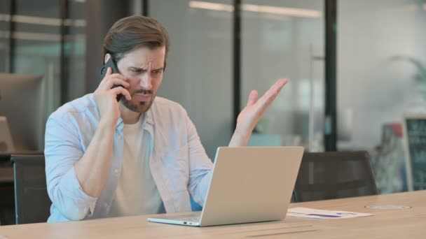Kızgın Olgun Yetişkin Adam dizüstü bilgisayarla telefonda konuşuyor. — Stok video