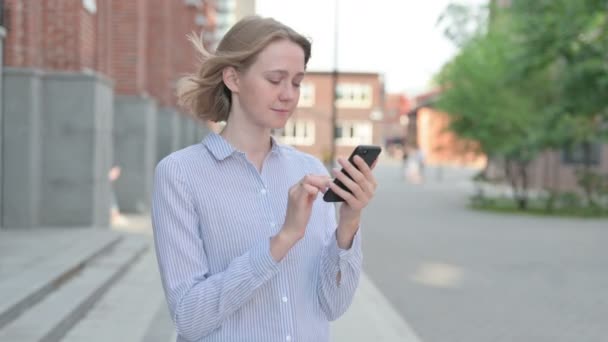 Woman using Smartphone while Standing in Street — Stock Video