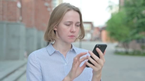 Portrait of Woman having Loss while using Smartphone — Stock Video