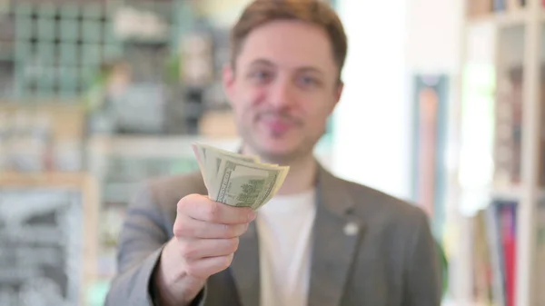 Portrait of Young Man Giving Away Dollars — Stock Photo, Image