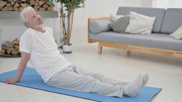 Tired Old Man after Doing Exercise and Stretching at Home