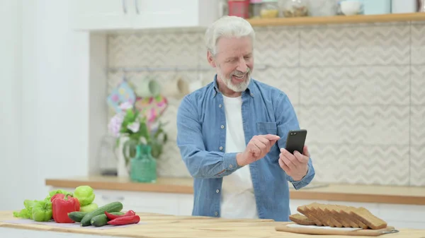 Old Man Taking Picture of Fruits on Smartphone in Kitchen