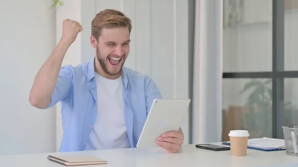 Successful Young Man Celebrating on Tablet
