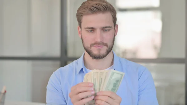 Portrait of Young Man Counting Dollars — Stock Photo, Image