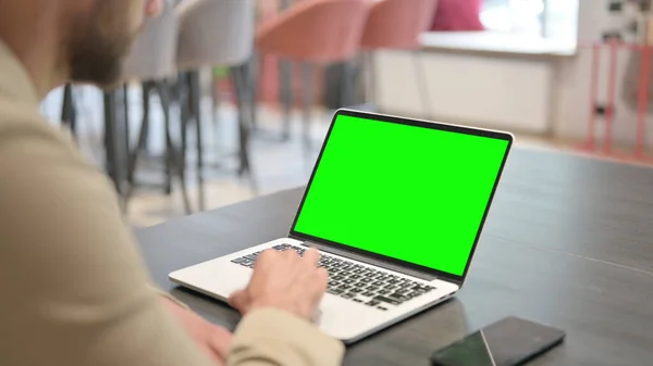 Hombre usando el ordenador portátil con pantalla verde —  Fotos de Stock