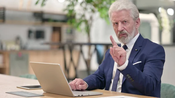 Old Businessman with Laptop showing No Sign with Finger — Stock Photo, Image