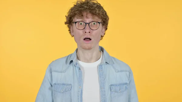 Redhead Young Man Feeling Shocked on Yellow Background — Stock Photo, Image