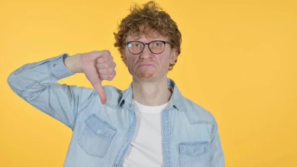 Redhead Young Man with Thumbs Down on Yellow Background — Stock Photo, Image