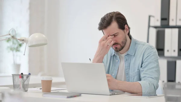 Człowiek z bólem głowy Praca na laptopie — Zdjęcie stockowe